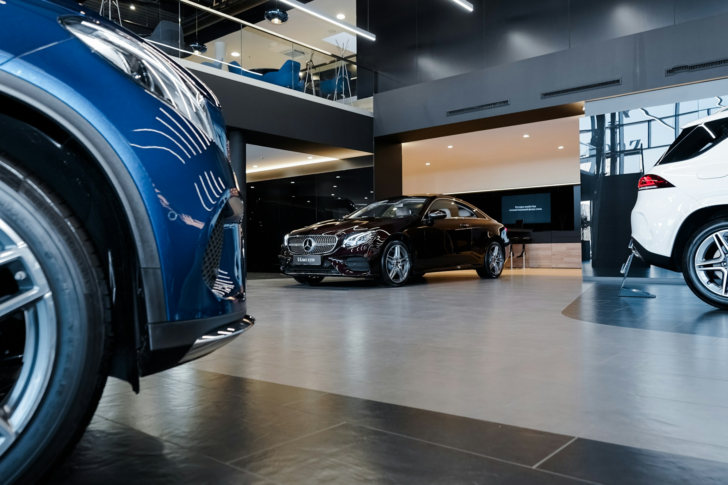 Luxury vehicles presented inside a modern dealership