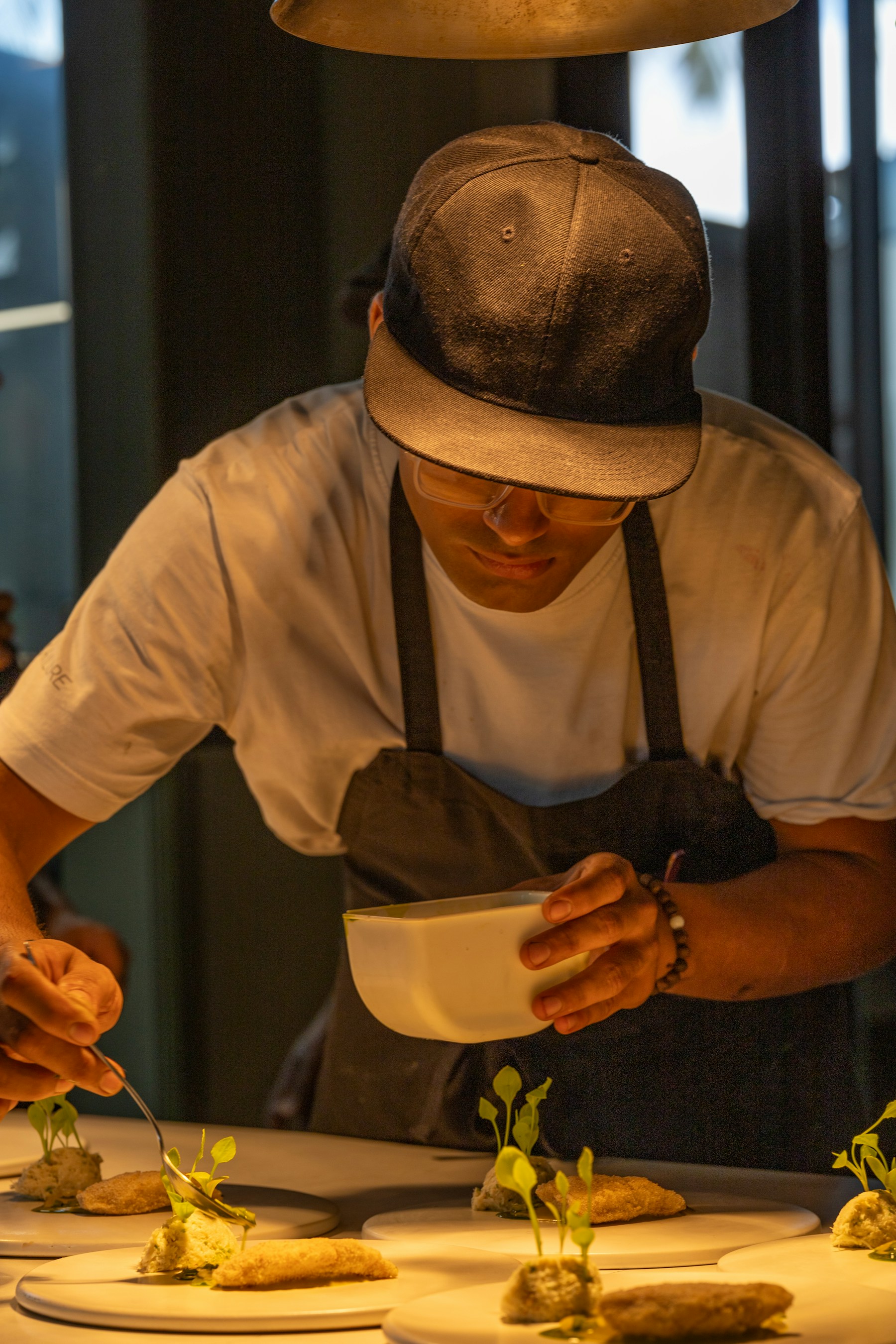 Chef carefully plating a dish in a restaurant kitchen